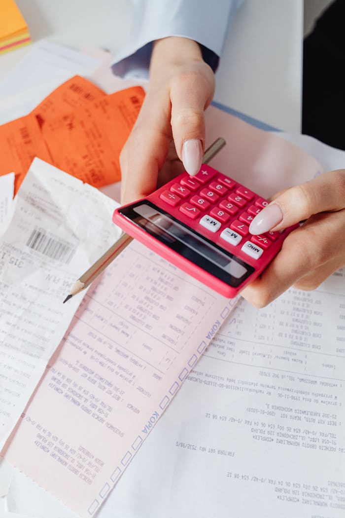 Close-Up Shot of a Person Holding a Calculator